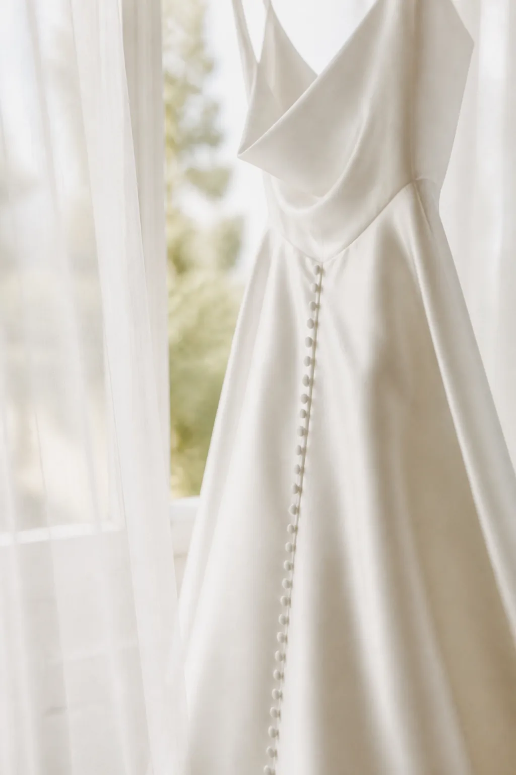 Silk wedding dress by a window